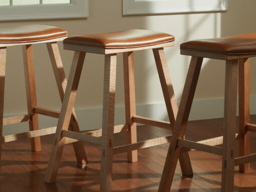 set of three tiger maple upholstered kitchen bars stools with caramel colored Italian leather seats