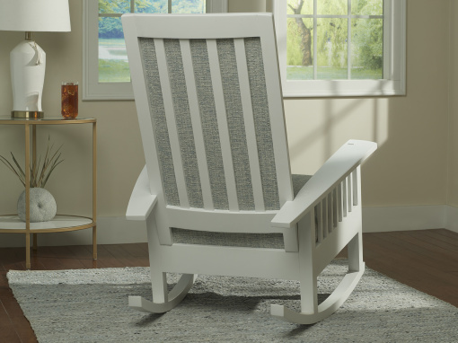 Back view of white rocking chair showing slatted back and boucle inset panels.