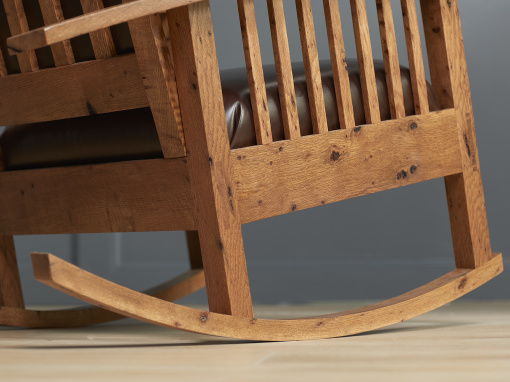 Close-up of rocker base showing mortise and tenon joinery in bark-included oak rocking chair.