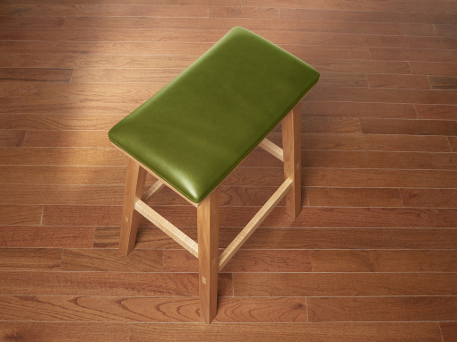 Handmade maple kitchen barstool with brown Italian leather seat on hardwood floor.