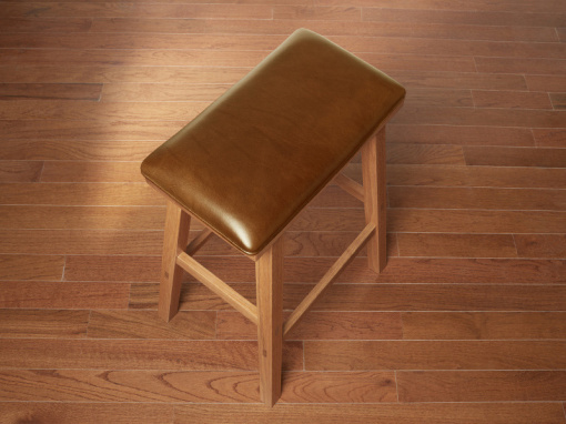 Handmade red oak kitchen barstool with London Bombay Italian leather seat on hardwood floor.