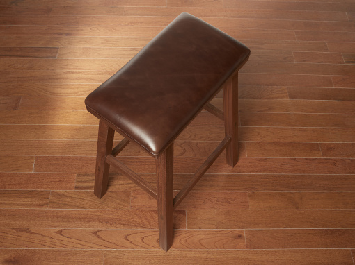 Handmade walnut kitchen barstool with London Cigar Italian leather seat on hardwood floor.