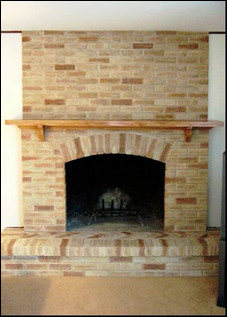 AFTER. A brown brick fireplace surround used to darken this room, causing it to blend in with the adjacent bookshelves. A lighter faux treatment now lets the fireplace pop. Photo courtesy of Brick Transformers.