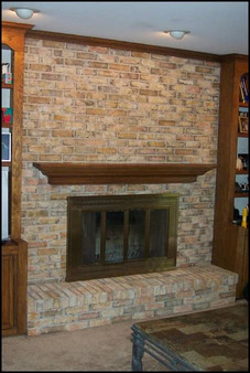 AFTER. Previously, this washed-out fireplace had no pizazz. Faux painting and a refinished mantle now subtly enhances the bricks, offering more depth and character. Photo courtesy of Brick Transformers.