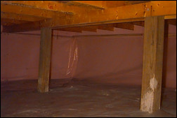 AFTER. Removing the fallen insulation and installing a vapor barrier liner on the walls and the floor help give this crawl space a clean, finished look. Photo courtesy of the Crawlspace Doctor.
